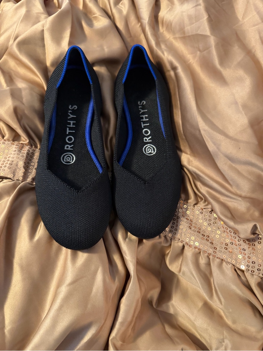 Rothy's Black Slip-On Flats with Blue Trim